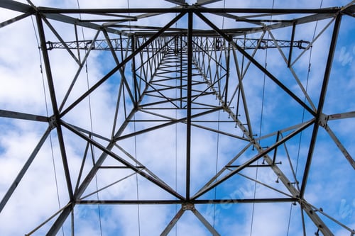 Preview: Low-angle shot of an electrical tower on a cloudy sky