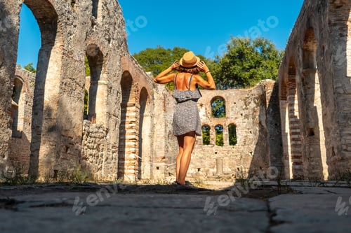 Preview: A tourist visiting in Great basilica in the archaeological ruins of Butrint National Park