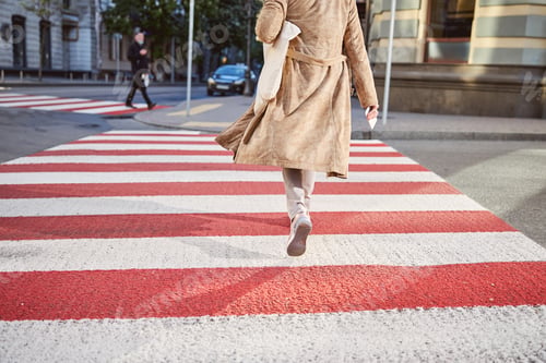 Preview: Back view of aged woman crossing the road