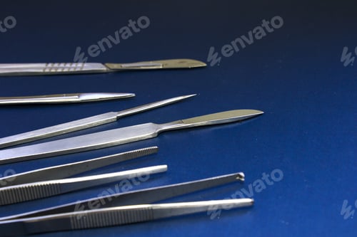 Preview: Closeup shot of a medical dissection kit on a blue surface