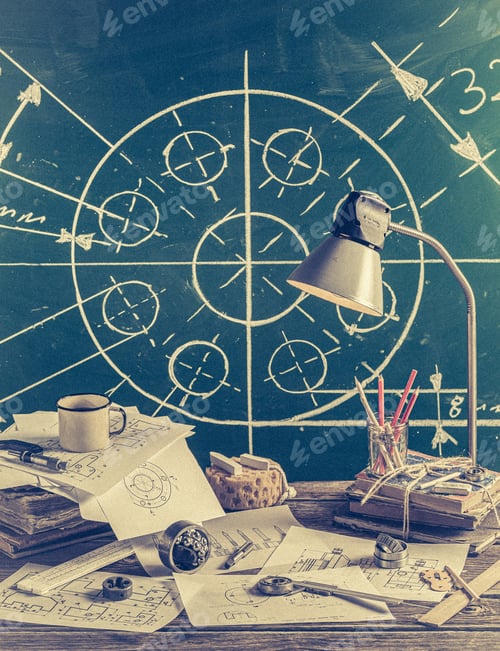 Preview: Mechanical engineer desk at the school on green chalkboard background