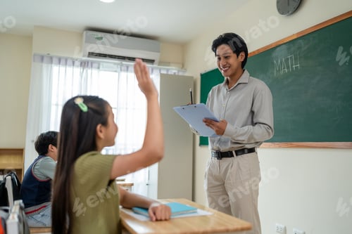 Preview: Asian male teacher educating group of students at elementary school.