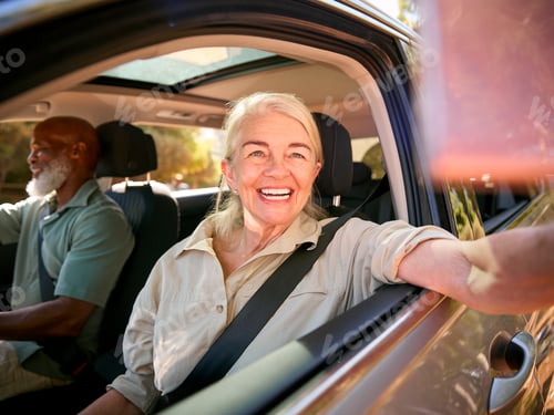 Preview: Female Passenger Taking Selfie On Mobile Phone As Two Senior Couple Enjoy Day Trip Out In Car