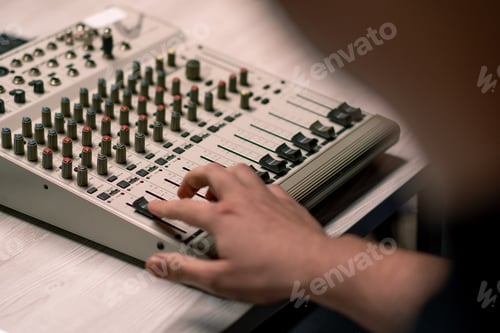 Preview: professional recording studio sound engineer with finger adjusts volume level mixing equalizer