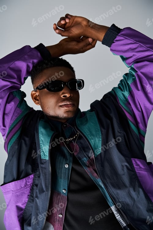Preview: Stylish African American Man Posing in Purple Jacket and Sunglasses