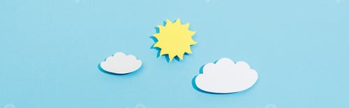 Preview: Top view of paper cut clouds and sun on blue background, panoramic shot