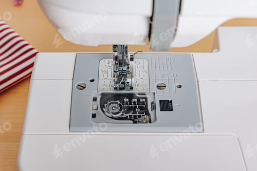 Preview: A Close-Up View of a Sewing Machine with Detailed Stitch Selector and Presser Foot