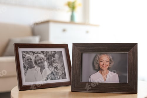 Preview: Portraits in stylish frames on table indoors