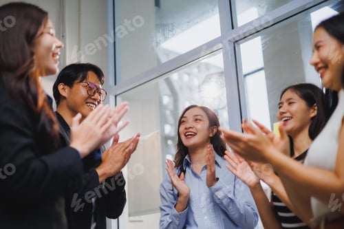 Preview: Enthusiastic business team clapping hands, celebrating success in the office