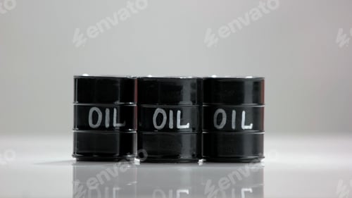 Preview: Three black oil barrels.