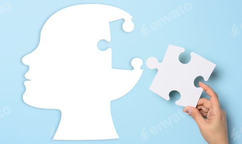Vista previa: Silhouette of a human head holding a puzzle piece on a blue background, representing mental health