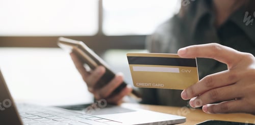 Preview: Hands holding credit card and using laptop. Online shopping.