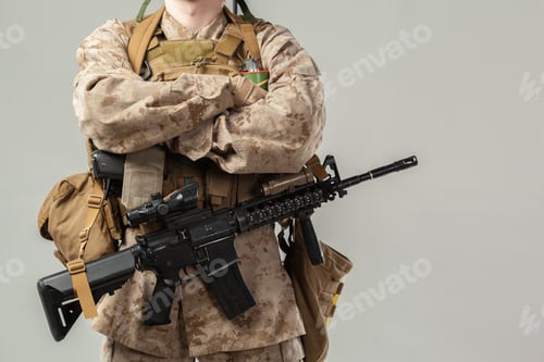 Preview: Soldier stands with arms crossed and weapon in hand at a neutral location