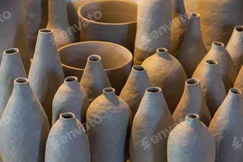 Preview: A symphony of ceramic elegance with unfinished pottery vases basking in warm light.