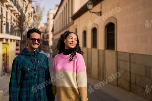 Preview: Happy tourist couple walking down a european street
