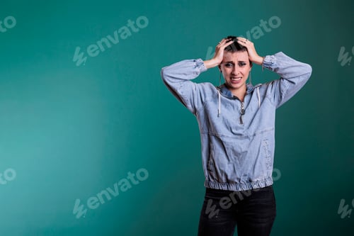 Preview: Upset nervous woman putting hand on head trying not to scream after hearing the news