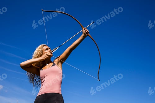 Preview: Archeress aiming with bow against blue sky