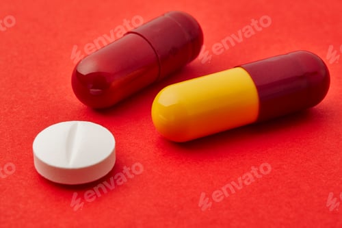 Preview: Pills over a red background. Medicament treatment. Health care photo