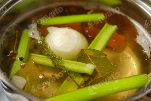 Preview: Cooking flavorful vegetable broth with fresh herbs and vegetables in a pot
