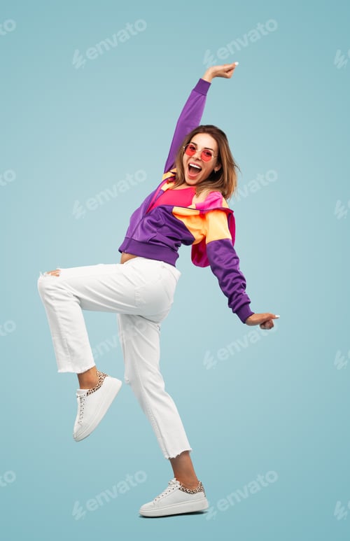 Preview: Cheerful young lady shouting happily while celebrating success against blue background