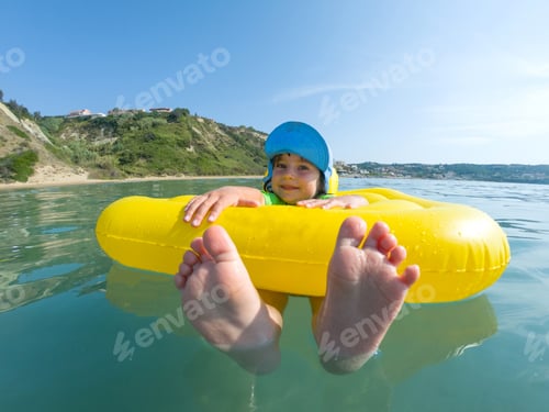 Preview: Kid swimming in rubber ring