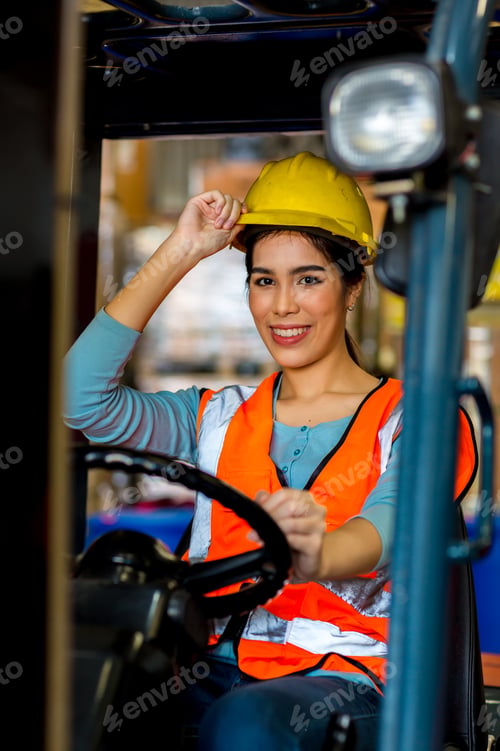 Preview: women worker at forklift driver happy working in industry factory logistic ship.