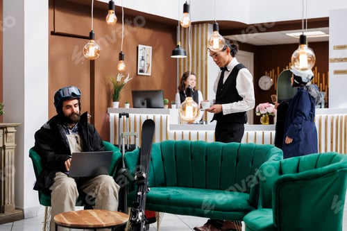 Preview: Staff carries coffee to man with laptop