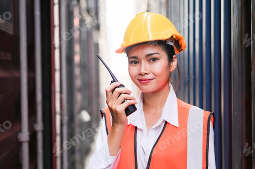 Preview: Portrait of Asian female worker talking to walkie talkie