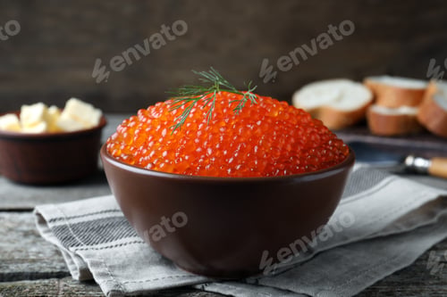 Preview: Bowl with delicious red caviar and dill on wooden table