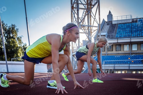 Preview: Two female sprinter athlete in the athletics stadium.