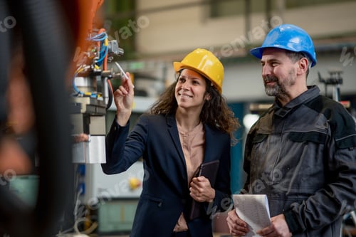 Preview: Female engineering manager and mechanic worker doing routine check up in industrial factory