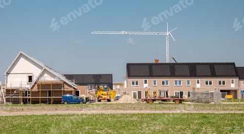 Preview: Newly build houses with solar panels attached on the roof against a sunny sky