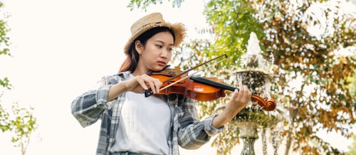 Preview: Close-up portrait of Young Asia woman music violinist play violin, relax in the garden