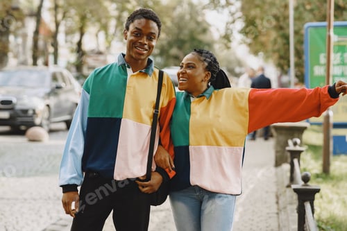 Preview: Ethnic couple walking in city street