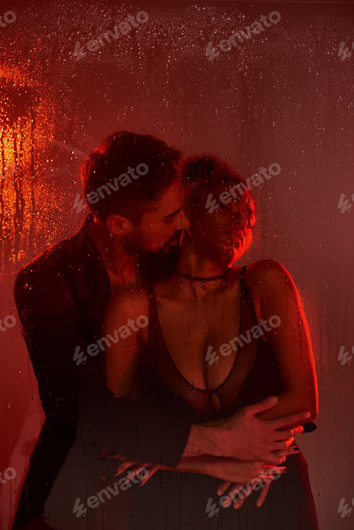 Preview: Intimate moments shared between a loving couple surrounded by soft red light and rain