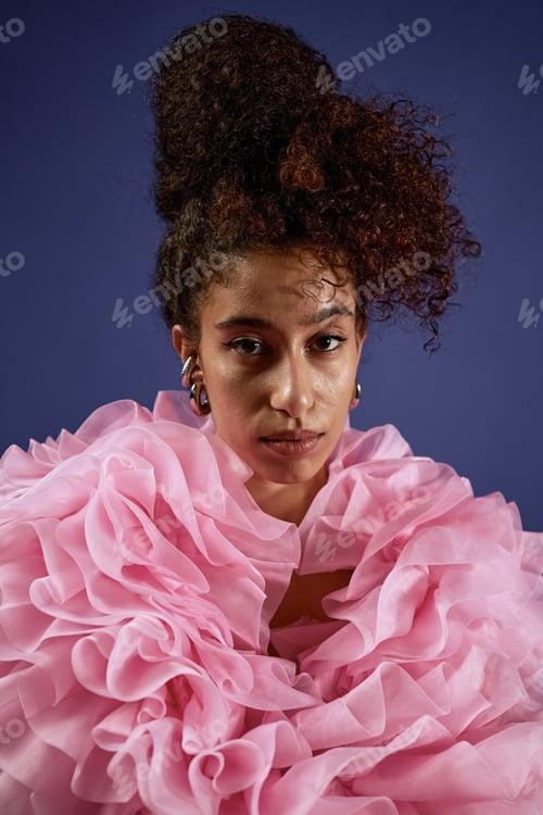 Preview: Portrait of Young Woman Wearing Pink Ruffles Facing Camera