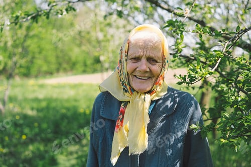 Preview: Portrait of an old happy woman in a yellow headscarf.