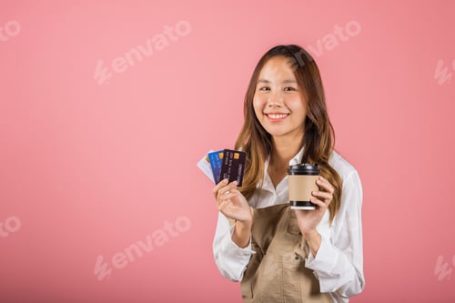 Preview: Portrait Asian happy young woman barista bar tender coffee maker holding coffee tea hot cup and