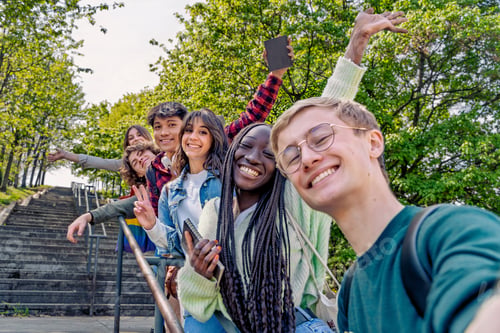 Preview: Happy students taking a selfie outdoors, enjoying nature and friendship