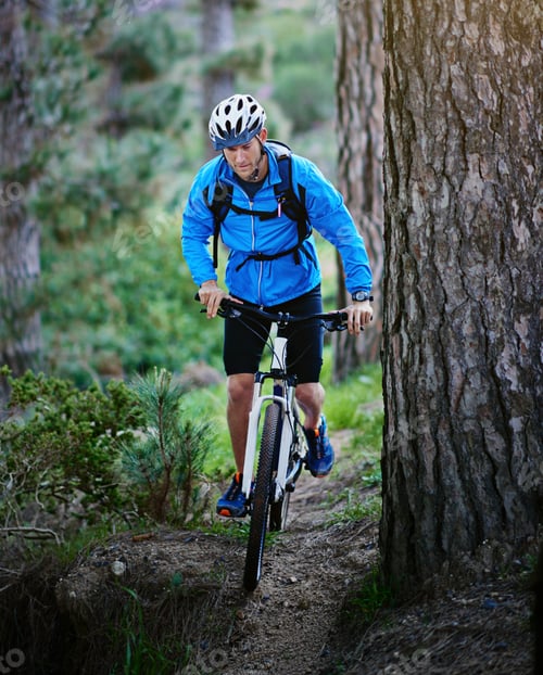 Preview: Hes one determined mountain biker. Shot of a male cyclist riding along a mountain bike trail.
