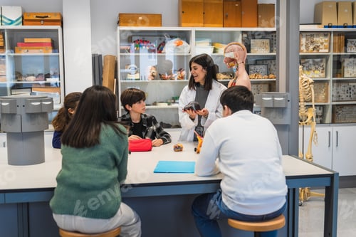 Preview: Biology teacher showing anatomical model to students in laboratory