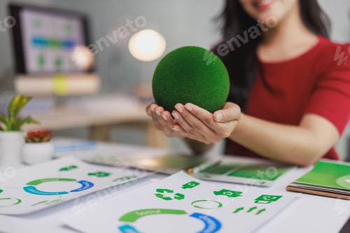 Preview: Woman holding green sphere promoting environmental sustainability concept