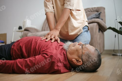 Preview: Elderly Man Laying Down With Cardiac Arrest Helped By Person Doing Emergency Cpr At Home