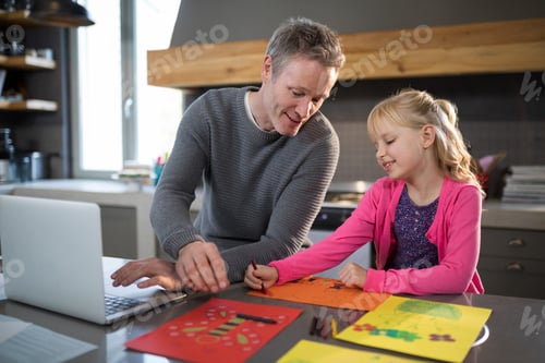 Preview: Father assisting daughter while coloring