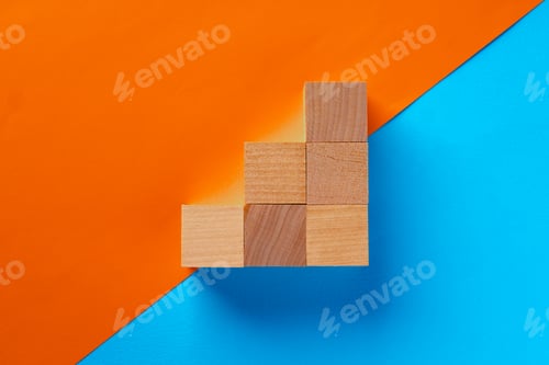Preview: Wooden square blocks on orange and blue background