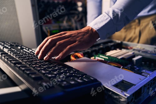Preview: Expert male system administrator upgrading computer components