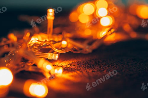 Preview: Illuminated garland close up on dark background
