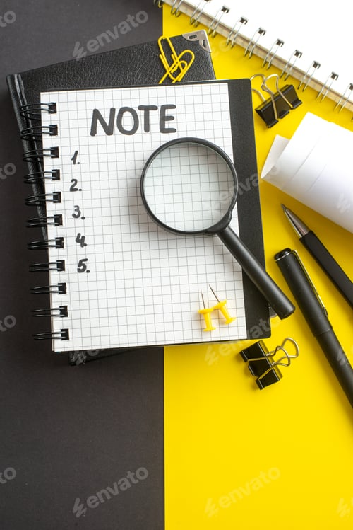 Preview: top view open notepad with note and numbers inside on dark-yellow background office success