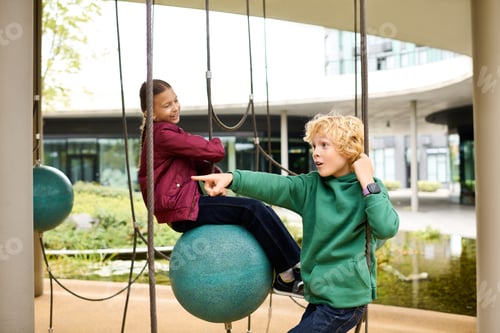 Preview: Children enjoy autumn fun on swings in a vibrant playground setting filled with joy