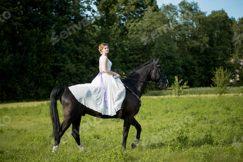 Preview: Beautiful and stunning bride, riding a horse in the nature, on her wedding day